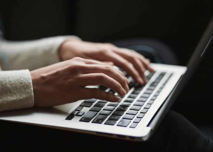 Person typing on a keyboard